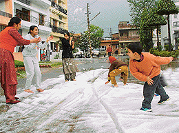 The Young and old come out of their homes to play with hailstones after a storm in SAS Nagar on Friday