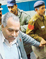 Arrested  Burai Jail Superintendent D.S. Rana  being taken to a court in Chandigarh on Friday. 