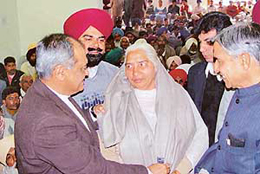 Mr Pawan Bansal, MP, and Mr Venod Sharma, a former MP, honour a sarpanch of a newly elected panchayat at Congress Bhavan in Chandigarh, on Friday. 