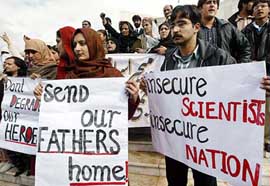 Family members of detained nuclear scientists hold placards and protest in front of the Supreme Court of Pakistan