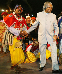 President A. P. J. Abdul Kalam holds the hand of a folk dancer rehearsing for the Republic Day celebrations in New Delhi on Saturday.
