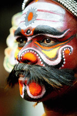 A dancer dressed as a Hindu deity watches a traditional dance drama in Kolkata 
