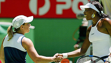 Venus Williams of the US shakes hand with compatriot Lisa Raymond 