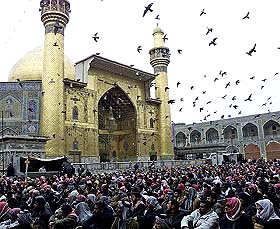 Followers of Iraq�s Shia cleric Ayatollah Ali al-Sistani attend Friday prayers at the Imam Ali shrine in Najaf