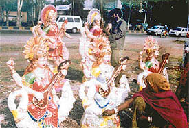 Artists give finishing touches to idols of goddess Saraswati in connection with Basant Panchami
