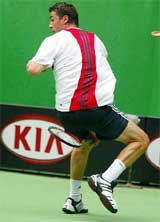 Russia's Marat Safin plays a shot between his legs to James Blake of the US 