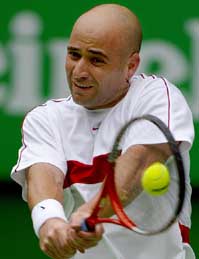 Fourth seed Andre Agassi of the US hits a backhand to Thailand's Paradorn Srichaphan