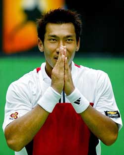 Thailand's Paradorn Srichaphan performs a traditional Thai greeting after his fourth round defeat against Andre Agassi of the US