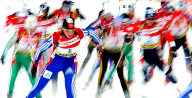 This long exposure picture shows skiers begin the women's 12.5-km mass start competition at the Biathlon World Cup in the northern Italian skiing resort of Anterselva 