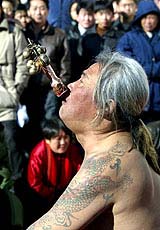 A Chinese martial arts expert swallows a sword during a performance at a temple fair in Beijing 