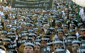 Cambodian union members wear black headbands calling trade union leader Chea Vichea a "worker's hero" at a silent funeral march in Phnom Penh