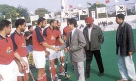 Hockey Olympian Pargat Singh meeting players in the DDA Hockey Tournament