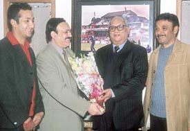 Board of Control for Cricket in India treasurer Jyoti Bajpai is being felicitated by Chand Khanna Club secretary C K Khanna and other officials, Kashyap and Tanwar