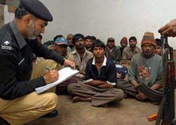 A Pakistani police officer investigates the Indian fishermen in Karachi