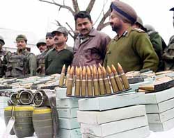Border Security Force officials display ammunition and explosives seized from a Hizb-ul-Mujahideen dump