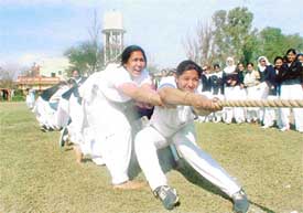 Girls use their might to win a tug-of-war competition during the annual sports day of Khalsa College for Girls, Ghumar Mandi