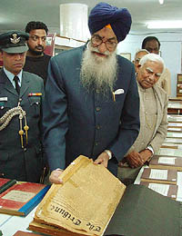 Andhra Pradesh Governor Surjit Singh Barnala going through The Tribune files of 1922 at Lajpat Rai Bhavan in Chandigarh