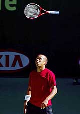 Morocco's Hicham Arazi throws his racquet during his quarter-final match against third seed Juan Carlos Ferrero of Spain at the Australian Open