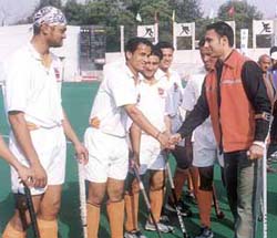 Indian hockey star Jugraj Singh, who is recovering from a car crash, meeting players of the Indian Oil Corporation and Punjab Police during the DDA Hockey Tournament at the Shivaji Stadium on Thursday.
