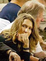 Former German tennis player Steffi Graf watches her husband and fourth seed Andre Agassi of the US during his semifinal match against Russia's Marat Safin