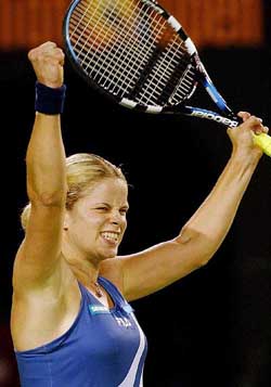 Belgium's Kim Clijsters raises her arms in celebration after her semifinal win over Switzerland's Patty Schnyder