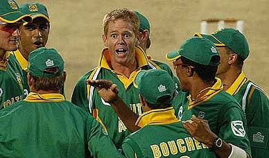 South African bowler Shaun Pollock talks to his team-mates after dismissing Chris Gayle of the West Indies 