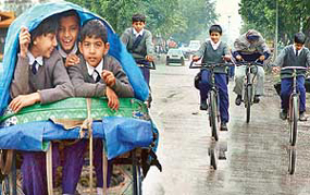 Students huddle together to beat the chill as the drizzle continued throughout the day in Chandigarh