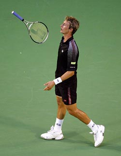 Third seed Juan Carlos Ferrero of Spain throws his racquet during his semifinal match against second seed Roger Federer 