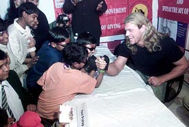 World Wrestling Entertainment superstar Edge interacts with homeless and street children at a Press conference in New Delhi 