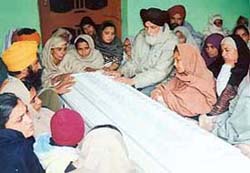 Ikwinder�s parents with her coffin in Kalsan village near Raikot on Saturday