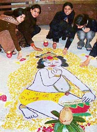 Students make a rangoli during �Ectopia-04� at Dayanand Medical College and Hospital in Ludhiana on Saturday.