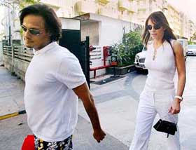 Indian businessman Arun Nayar and Hollywood star Elizabeth Hurley walk out of a shopping centre in Mumbai