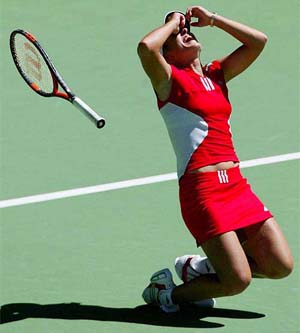 Belgium's Justine Henin-Hardenne throws her racket in the air as she celebrates her win in women's singles final 