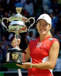 Justine Henin-Hardenne of Belgium holds the winner's trophy after beating compatriot Kim Clijsters in the women's final of the Australian Open 