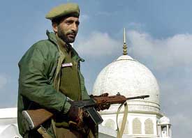 A policeman stands guard at the Hazratbal shrine in Kashmir during Id prayers