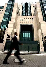 A man walks past the MI6 building, the home of Britain's foreign intelligence services, in London on Monday