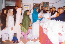 Mr Jagmohan Sharma, president, DCC, distributes ration among needy women at a camp organised by the Punjab Nishkam Sewa Dal