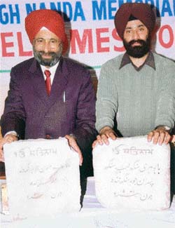 Mr N.S. Nanda and his son Devinder Bir Singh with the marble slabs carrying the names of their ancestors