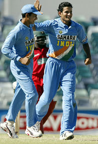 India's Irfan Pathan celebrates with Sanjay Bangar after taking the wicket of Zimbabwe's Raymond Price during the triangular series One-Day International in Perth