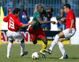 Cameroon midfielder Geremi Fotso Njitap is tackled by Egypt's Tarek Said and Tarek El Sayed during their African Nations Cup soccer match