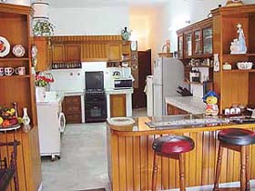 The open kitchen makes the dining room area appear more spacious
