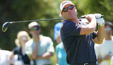 Australian cricketer Shane Warne tees off during the Heineken Classic Golf tournament ProAm 