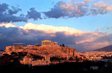 Sunlight catches clouds behind the ancient Acropolis in Athens on Tuesday