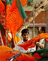 BJP workers carry party flags on the eve of an election campaign rally in Faizabad 