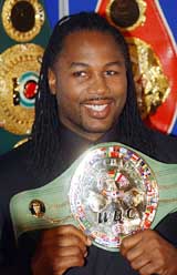World heavyweight boxing champion Lennox Lewis holds his WBC belt after announcing his retirement from professional boxing