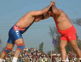 Randhir Singh of India and Mohammad Nasir of Pakistan in action during their wrestling match at the 5th International Rural Sports festival in Amritsar 