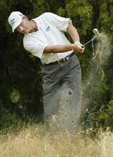 South Africa's Ernie Els hits out from the rough after his ball hit off the 9th Tee on the third day of the Heineken Open in Melbourne 