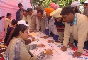 Consumers at an enquiry counter at an SBI loan mela in Ludhiana on Sunday.