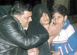 Five-year-old Shahbaz Khan with his parents in the Capital on Sunday. 