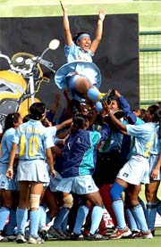 Indian women�s hockey team members toss their captain Surja Lata Devi in air as they celebrate the victory over Japan in the final of the fifth women�s Asia Cup in New Delhi